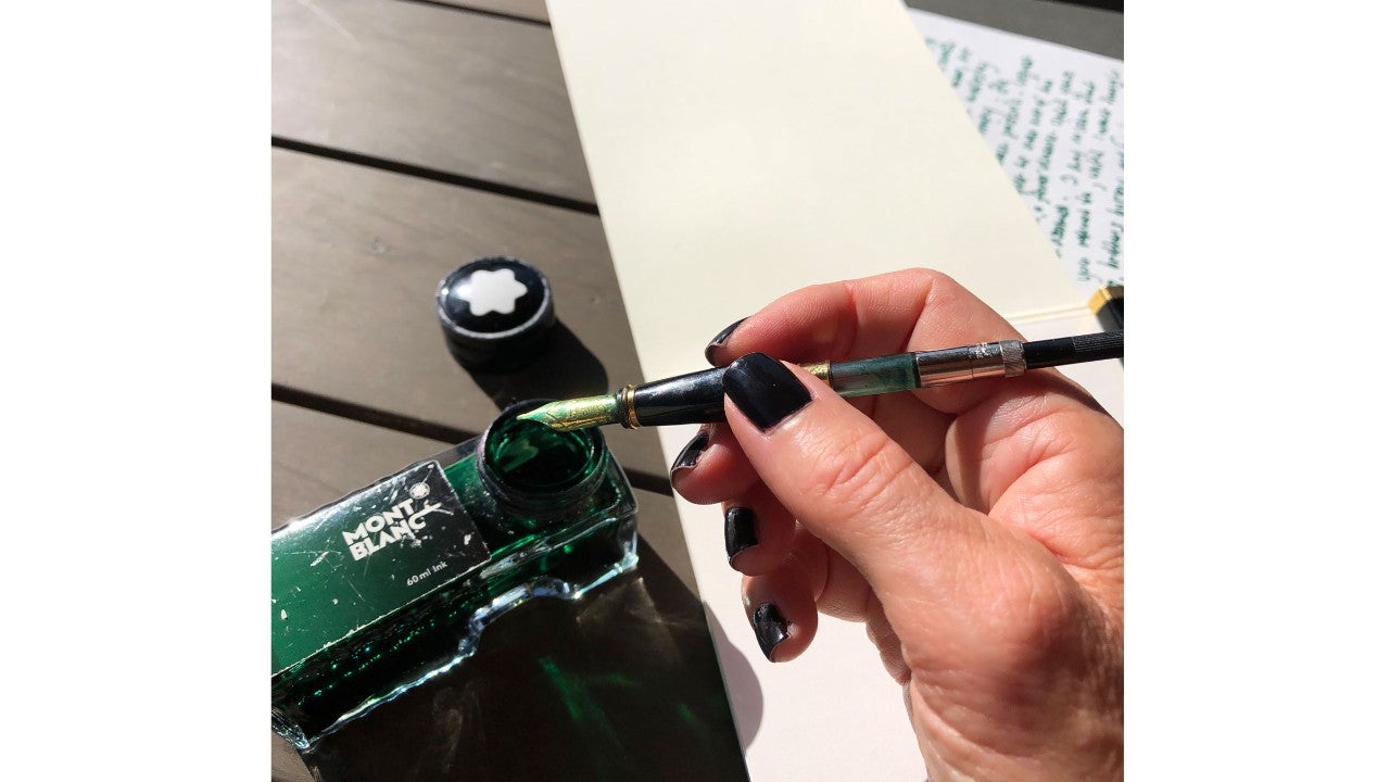 photo-woman-dipping-ink-in-inkwell