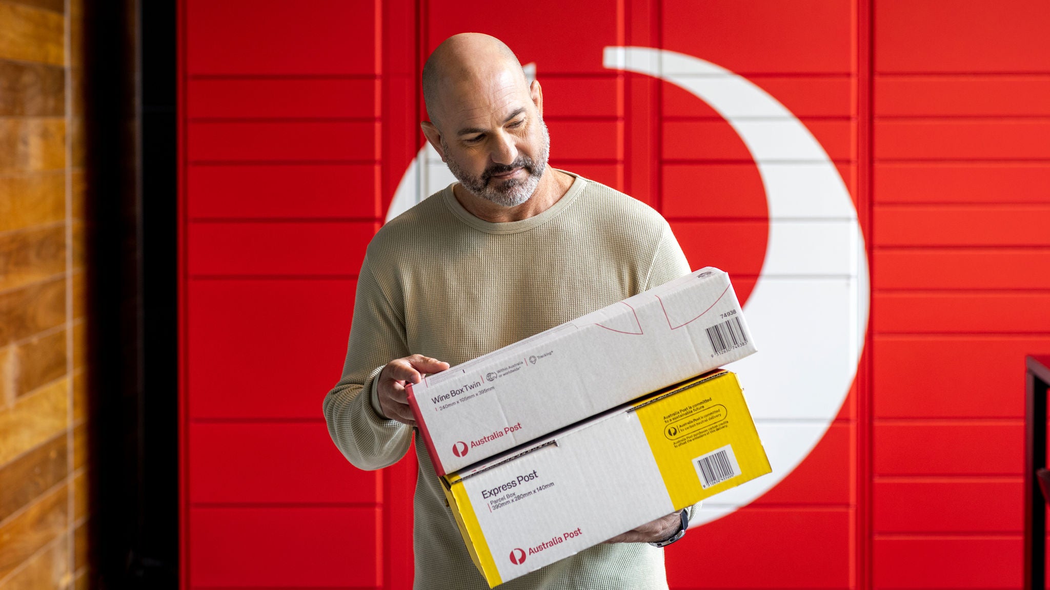 photo-man-bald-beard-holding-wine-box-express-post-parcels-boxes