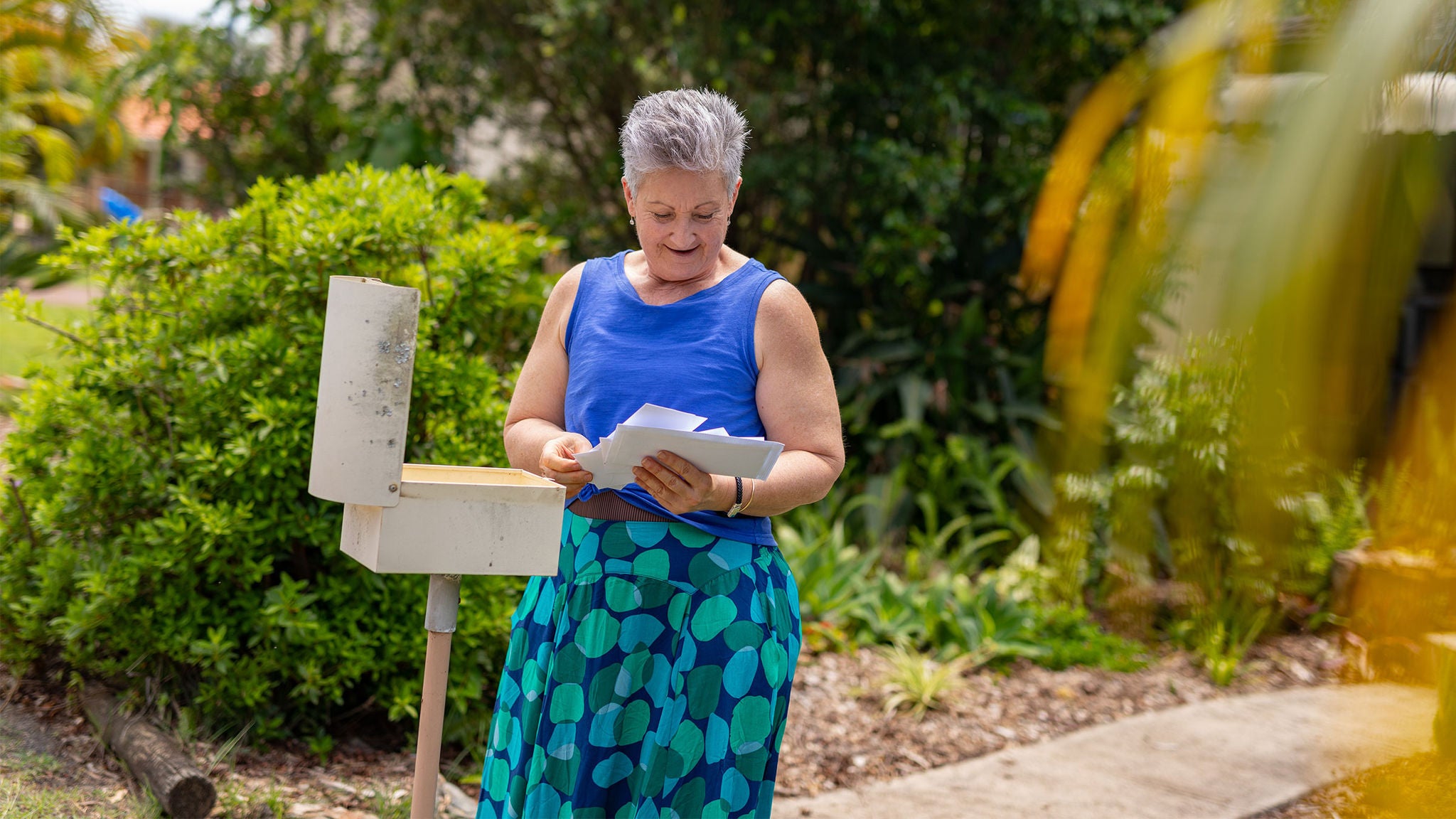 photo-woman-checking-the-mail-at-her-letterbox
