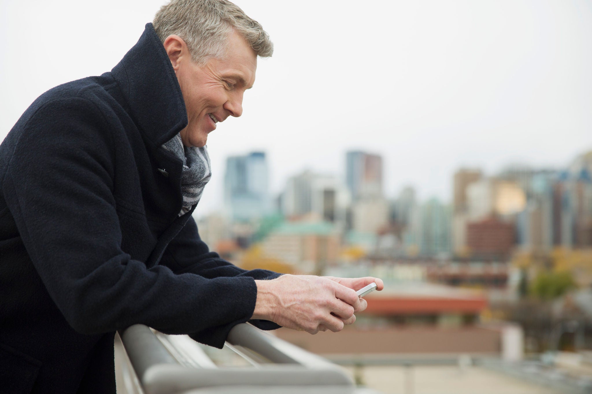 photo-man-black-jacket-coat-grey-hair-outdoors-phone