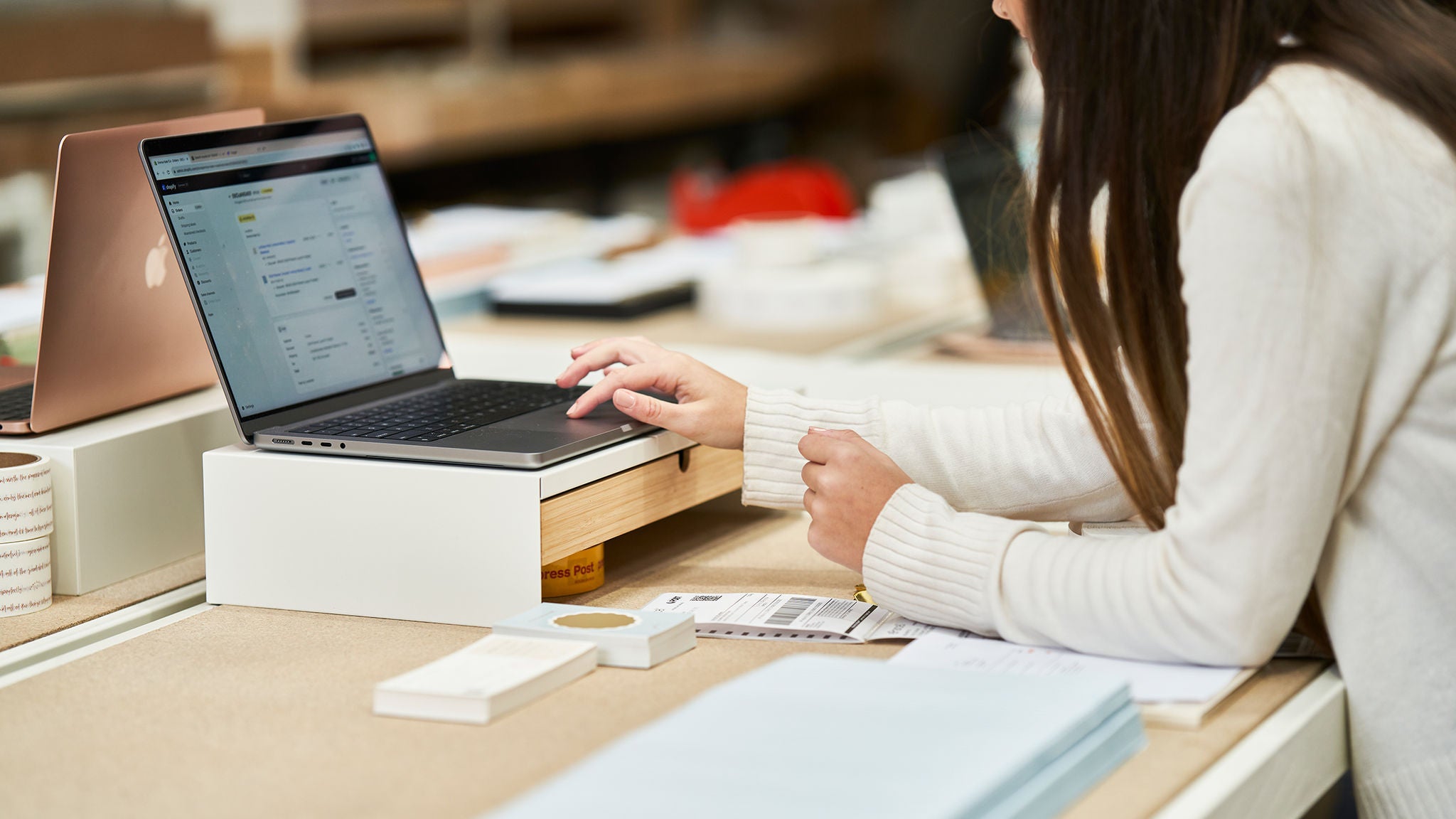 photo-woman-using-laptop-with-shipping-labels-nearby