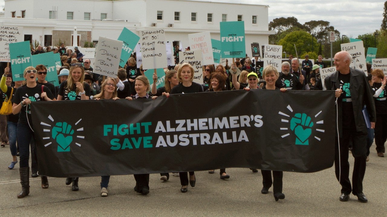 photo ita buttrose marching with group fight alzheimers banner