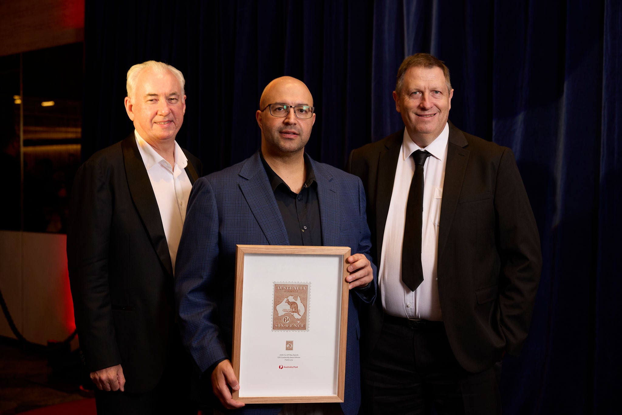 An image of our Australia Post team members on stage accepting the Internal Talent Award