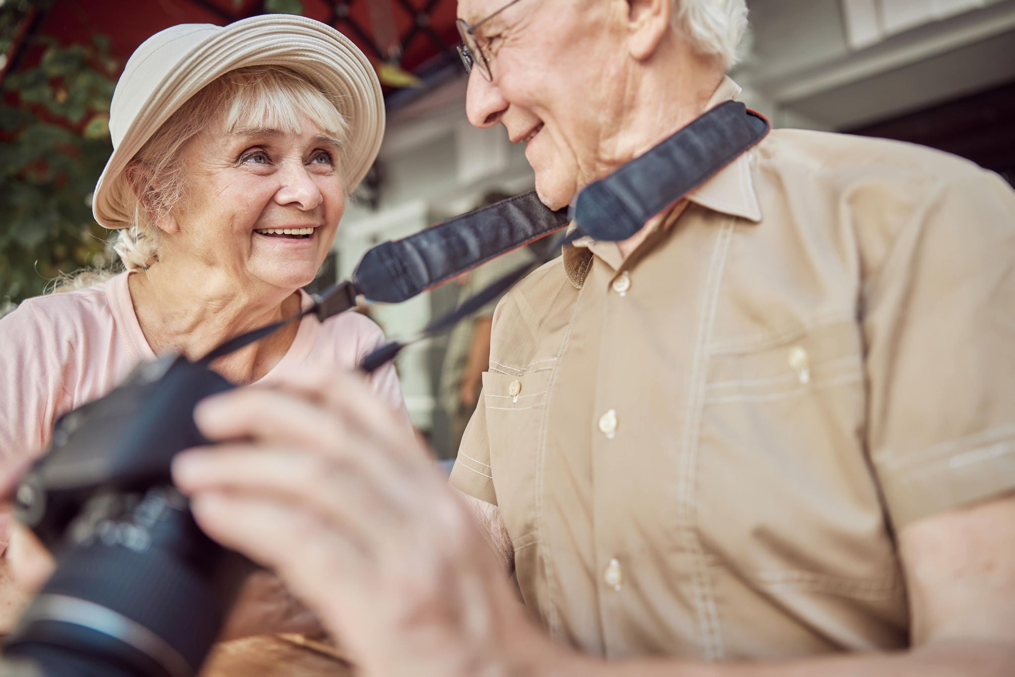 photo-older-couple-smiling-to-each-other-holding-camera
