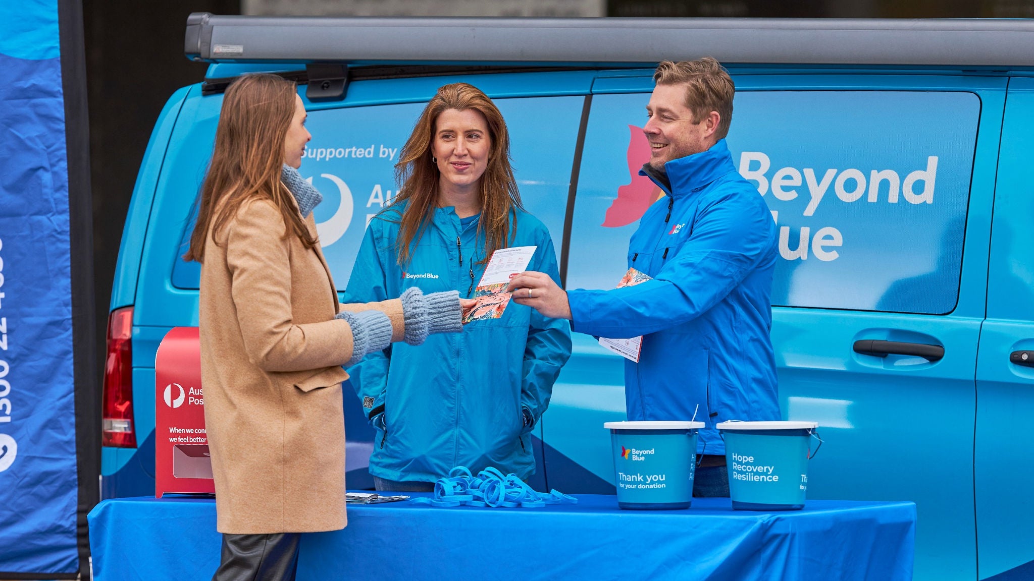 photo-beyond-blue-van-at-event-handing-out-information