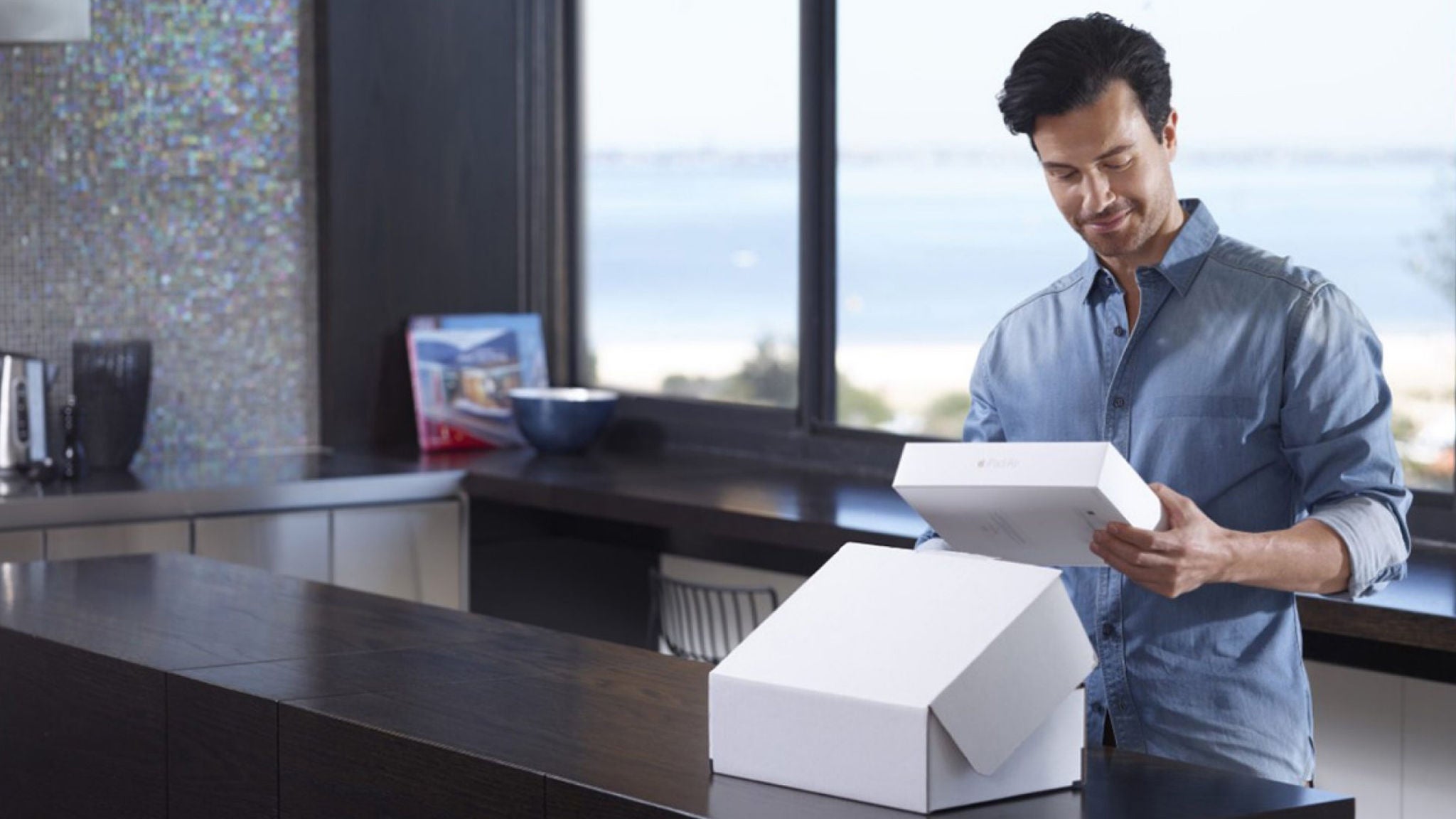 photo-man-standing-at-bench-opening-a-plain-box