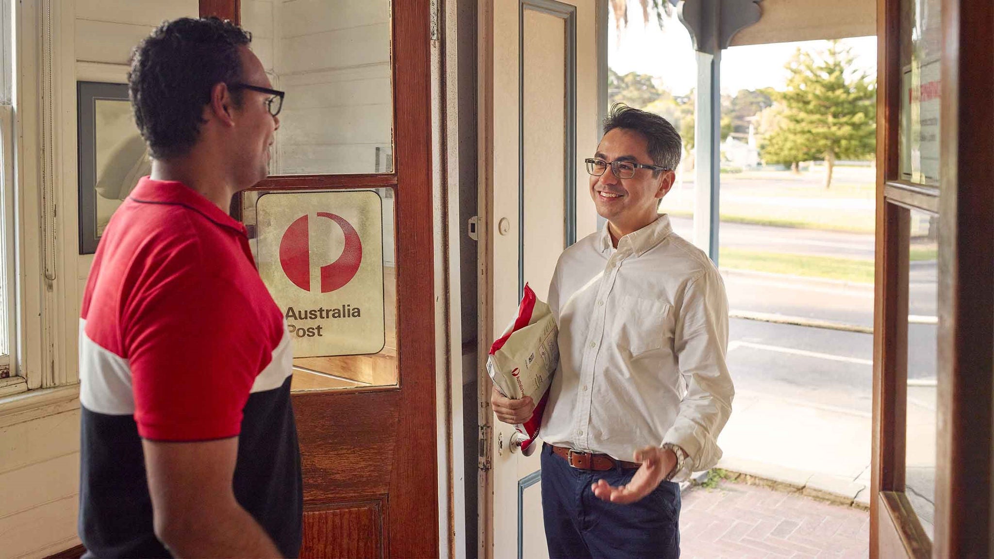 two men standing in post office doorway