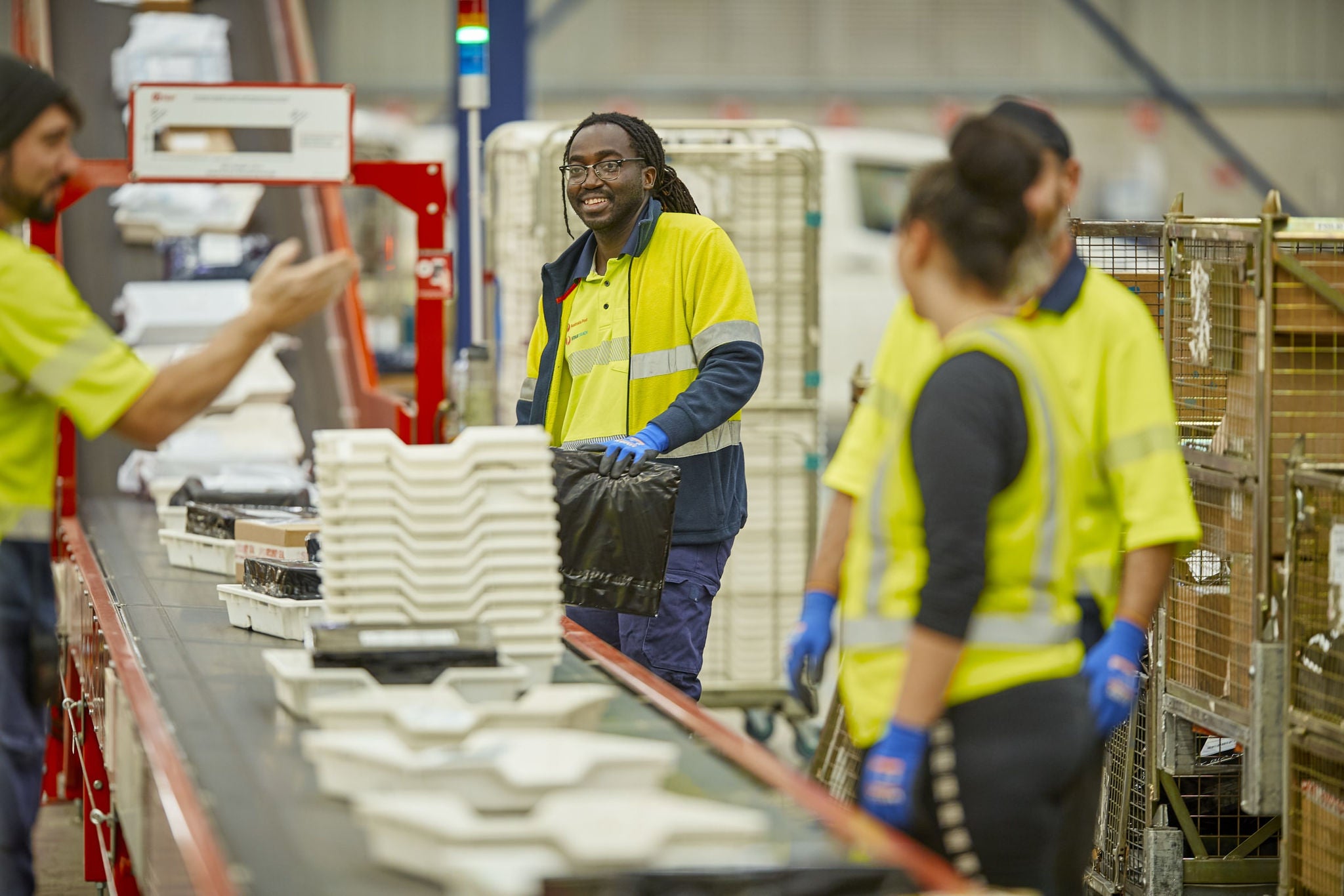 Several workers in a warehouse or distribution center.