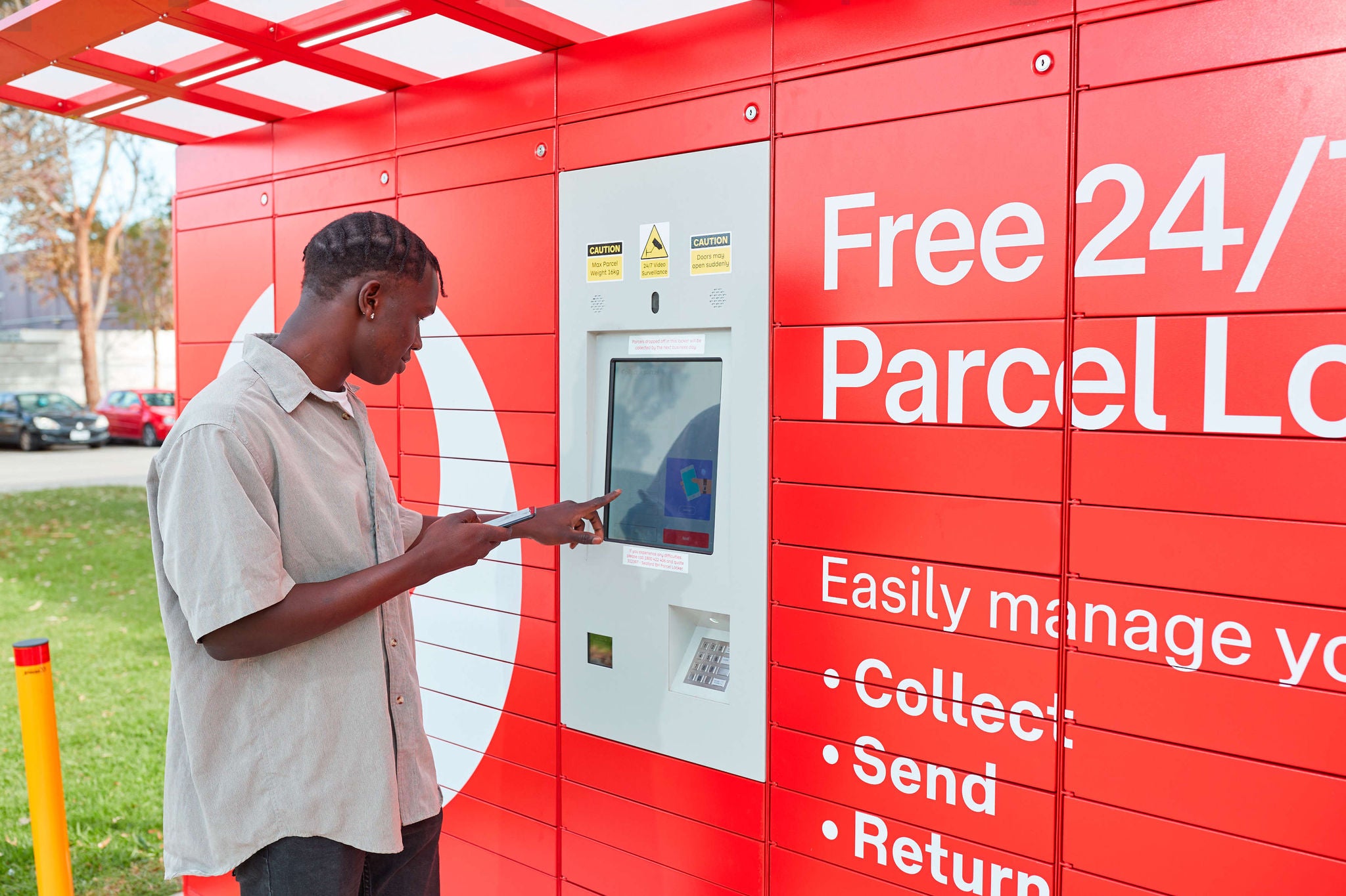 A customer using parcel locker using a phone